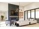 Spacious living room featuring a modern fireplace, built-in shelving, and large windows at 0 N Marchant Trace --, Queen Creek, AZ 85144