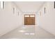 Spacious three-car garage with modern wood door at 0 N Marchant Trace --, Queen Creek, AZ 85144