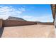 Large backyard with block wall and sandy ground at 37607 W Padilla St, Maricopa, AZ 85138