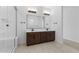 Bathroom with double vanity and large mirror at 37607 W Padilla St, Maricopa, AZ 85138
