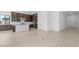 Living room with kitchen view and sliding door to backyard at 37607 W Padilla St, Maricopa, AZ 85138