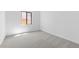 Spacious bedroom with neutral carpeting and large window at 37607 W Padilla St, Maricopa, AZ 85138