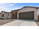 New single story home with a two-car garage and stone accents at 37607 W Padilla St, Maricopa, AZ 85138