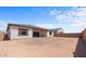 Large backyard with sandy ground and a view of neighboring house at 37607 W Padilla St, Maricopa, AZ 85138