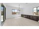 Bright dining room with light wood floors and built-in cabinetry at 37607 W Padilla St, Maricopa, AZ 85138
