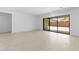 Bright living room with sliding glass doors leading to backyard at 37607 W Padilla St, Maricopa, AZ 85138