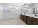 Elegant bathroom with double vanity and large walk-in shower at 37607 W Padilla St, Maricopa, AZ 85138