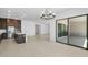 Open concept kitchen and living area with access to backyard patio at 37607 W Padilla St, Maricopa, AZ 85138