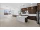 Modern kitchen with dark cabinets, white countertops, and an island at 37607 W Padilla St, Maricopa, AZ 85138