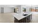 Modern kitchen island with white quartz countertop and dark cabinetry at 37607 W Padilla St, Maricopa, AZ 85138