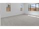 Spacious bedroom with neutral carpeting and large windows at 37607 W Padilla St, Maricopa, AZ 85138