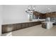 Modern kitchen with dark cabinets, white countertops, and an island at 37607 W Padilla St, Maricopa, AZ 85138