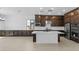 Modern kitchen with dark cabinets, white countertops, and an island at 37607 W Padilla St, Maricopa, AZ 85138
