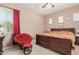 Spacious bedroom with a king-size bed and red accent chair at 3314 E Azalea Dr, Gilbert, AZ 85298