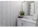 Modern bathroom with chevron patterned wallpaper and marble vanity at 3314 E Azalea Dr, Gilbert, AZ 85298