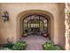 Elegant entryway with arched doorway and glass doors at 18826 N 101St Pl # 10, Scottsdale, AZ 85255