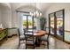 Charming dining room with wooden table and French doors at 18826 N 101St Pl # 10, Scottsdale, AZ 85255