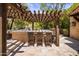 Outdoor kitchen with bar seating and pergola at 18826 N 101St Pl # 10, Scottsdale, AZ 85255