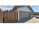 Attached garage with new gray door and wood fence at 4729 W Orangewood Ave, Glendale, AZ 85301