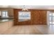 Dining area with wood paneled walls and tile floors at 7953 W Meadowbrook Ave, Phoenix, AZ 85033