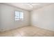 Simple bedroom with tile floors and a ceiling fan at 7953 W Meadowbrook Ave, Phoenix, AZ 85033