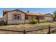 Ranch style home with a carport and wooden fence at 7953 W Meadowbrook Ave, Phoenix, AZ 85033