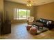 Bright living room with tiled floors, comfortable seating, and large window at 20234 N Mariposa Way, Surprise, AZ 85374