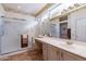 Bathroom boasts double sinks, large mirror, and shower at 20419 N Shadow Mountain Dr, Surprise, AZ 85374