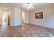 Spacious bedroom with tile flooring, ceiling fan, and access to bathroom at 20419 N Shadow Mountain Dr, Surprise, AZ 85374