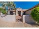 Front entrance with a decorative gate and mature palm tree at 20419 N Shadow Mountain Dr, Surprise, AZ 85374
