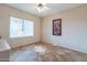 Bedroom with tile floors, built-in shelving, and window at 20419 N Shadow Mountain Dr, Surprise, AZ 85374