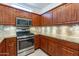 Well-equipped kitchen with stainless steel appliances and wood cabinets at 20419 N Shadow Mountain Dr, Surprise, AZ 85374