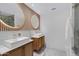 Modern bathroom with double vanity, marble floors, and circular mirrors at 7167 E Rancho Vista Dr # 3003, Scottsdale, AZ 85251