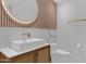 Modern bathroom with marble vanity, wood wall accents, and gold fixtures at 7167 E Rancho Vista Dr # 3003, Scottsdale, AZ 85251