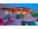 Stunning backyard oasis with a pool, patio, and mountain views at dusk at 13978 E Coyote E Rd, Scottsdale, AZ 85259