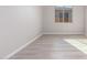 Bedroom with light grey vinyl plank flooring and a window offering natural light at 16423 W Avenida Del Sol --, Surprise, AZ 85387