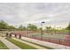 Well-lit tennis court with surrounding landscaping at 13330 W Milton Dr, Peoria, AZ 85383