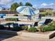 Relaxing community pool area with blue umbrellas at 40667 N Clubhouse St, San Tan Valley, AZ 85140