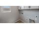 Bright laundry room with upper cabinets and vinyl flooring at 23148 E Carriage Way, Queen Creek, AZ 85142