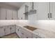 Modern kitchen with stainless steel appliances and white cabinetry at 23148 E Carriage Way, Queen Creek, AZ 85142
