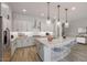 Bright kitchen featuring a large island, stainless steel appliances, and white cabinetry at 23148 E Carriage Way, Queen Creek, AZ 85142