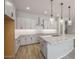 Modern kitchen with white cabinets, granite countertops, and a large island at 23148 E Carriage Way, Queen Creek, AZ 85142