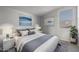 Bright bedroom featuring a queen bed and art pieces at 23148 E Carriage Way, Queen Creek, AZ 85142