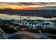 Community pool and clubhouse at sunset, with lake and mountain views at 23148 E Carriage Way, Queen Creek, AZ 85142