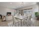 Elegant dining room features a marble table and access to the backyard at 23148 E Carriage Way, Queen Creek, AZ 85142