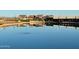 Tranquil lake reflecting the surrounding neighborhood at 22437 E Cattle Dr, Queen Creek, AZ 85142