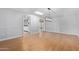 Spacious dining area with wood-look tile flooring and modern chandelier at 12406 W Cougar Dr, Sun City West, AZ 85375