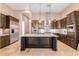 Spacious kitchen with island, stainless steel appliances, and dark wood cabinets at 2069 E Cedar Pl, Chandler, AZ 85249
