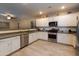 Modern kitchen with stainless steel appliances and white cabinets at 17135 W Diana Ave, Waddell, AZ 85355