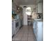 Galley kitchen with white appliances and light blue cabinets at 9627 W North Ln # B, Peoria, AZ 85345